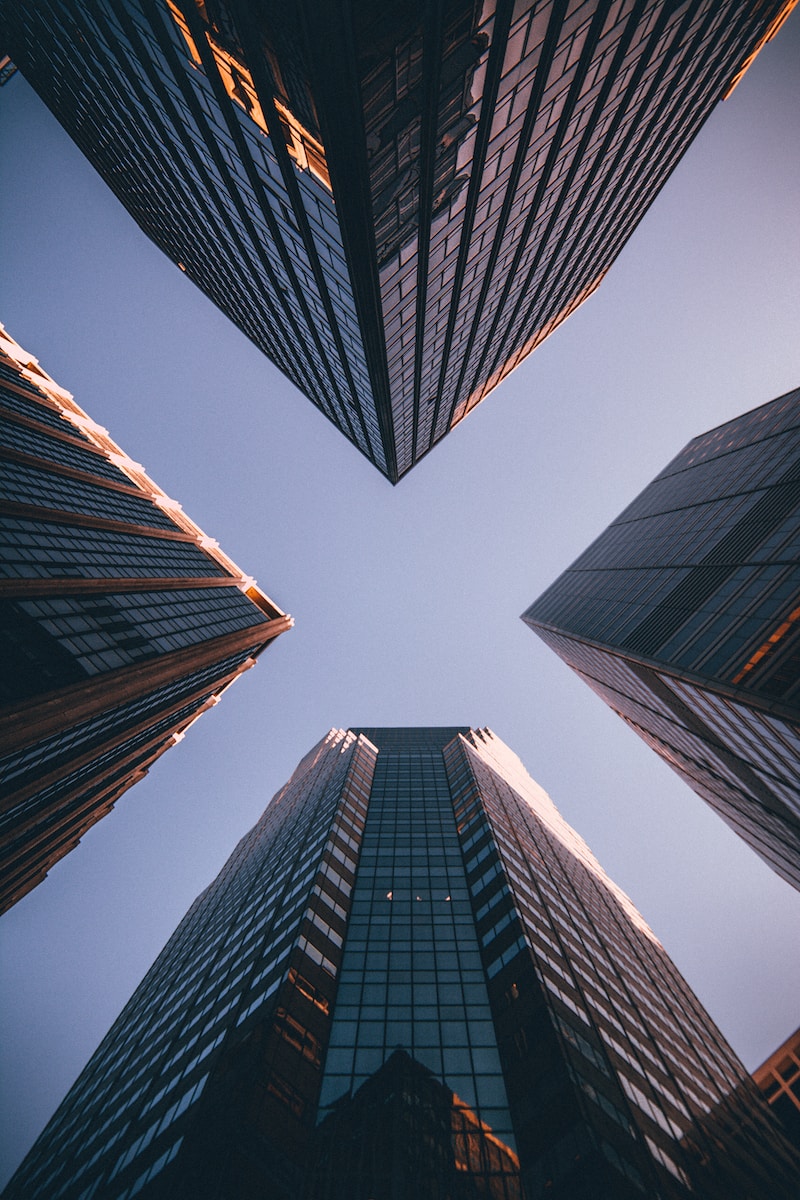 low-angle photography of four high-rise buildings